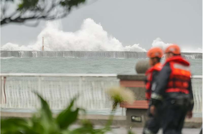 Waves crash over a breakwater at Sizihwan beach in Kaohsiung as Typhoon Krathon heads towards Taiwan